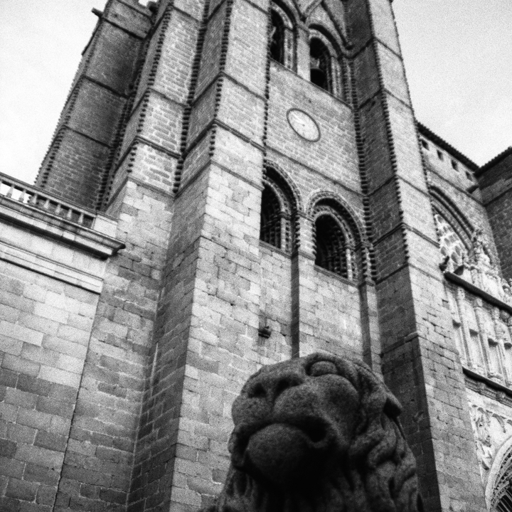  View of the belfry of the cathedral, protected by a stone lion, in Ávila, Spain 