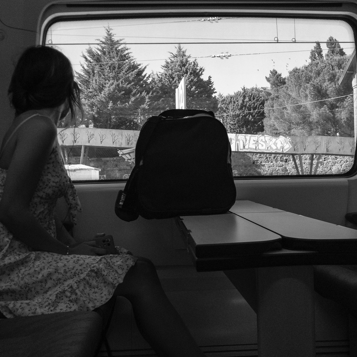 Young lady, looking through the window (no face)