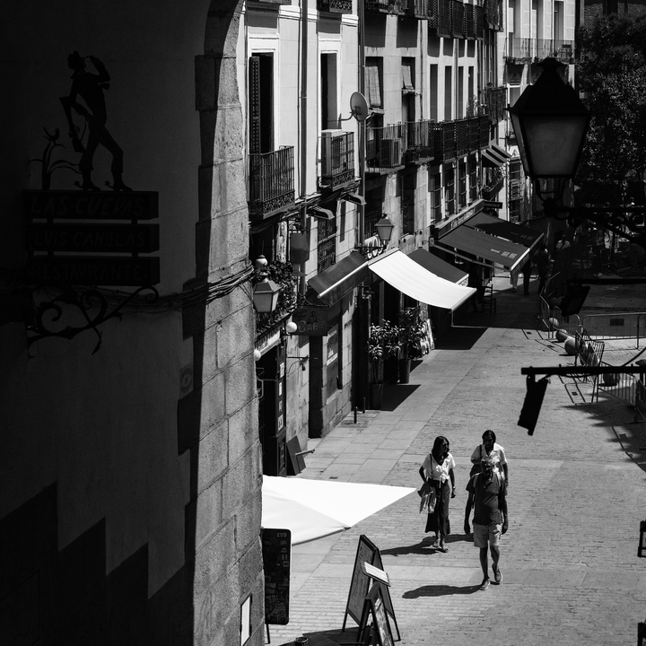  Summer street scene at Puerta de Cuchilleros steps leading to Plaza Mayor in Madrid, Spain. 