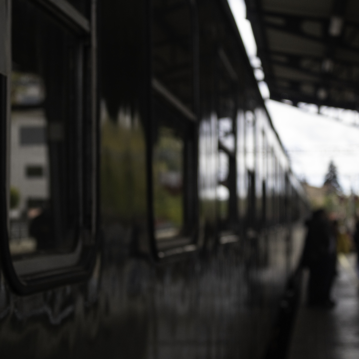  The historic Felipe II train stopped at El Escorial station. The green vintage carriage reflects the station's architecture and soft twilight ambiance, highlighting timeless railway heritage. 