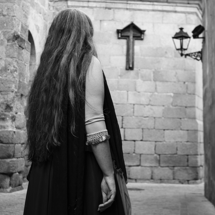 Young girl, with her back turned, at the Medieval Market at Avila, Spain