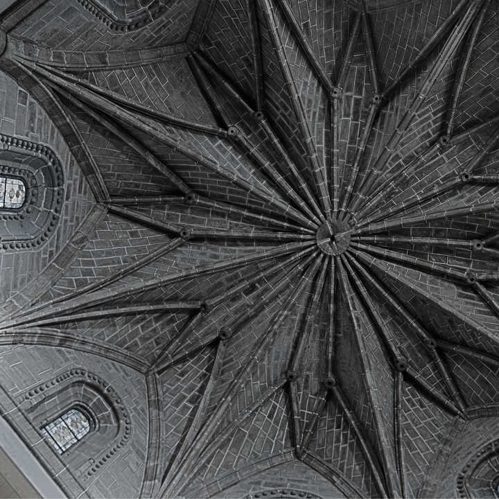 Detailed view of a Gothic-style ribbed vault ceiling with radial design in the Church of San Francisco in Ávila, Spain. The image captures the architectural craftsmanship and symmetry of medieval stone masonry. 